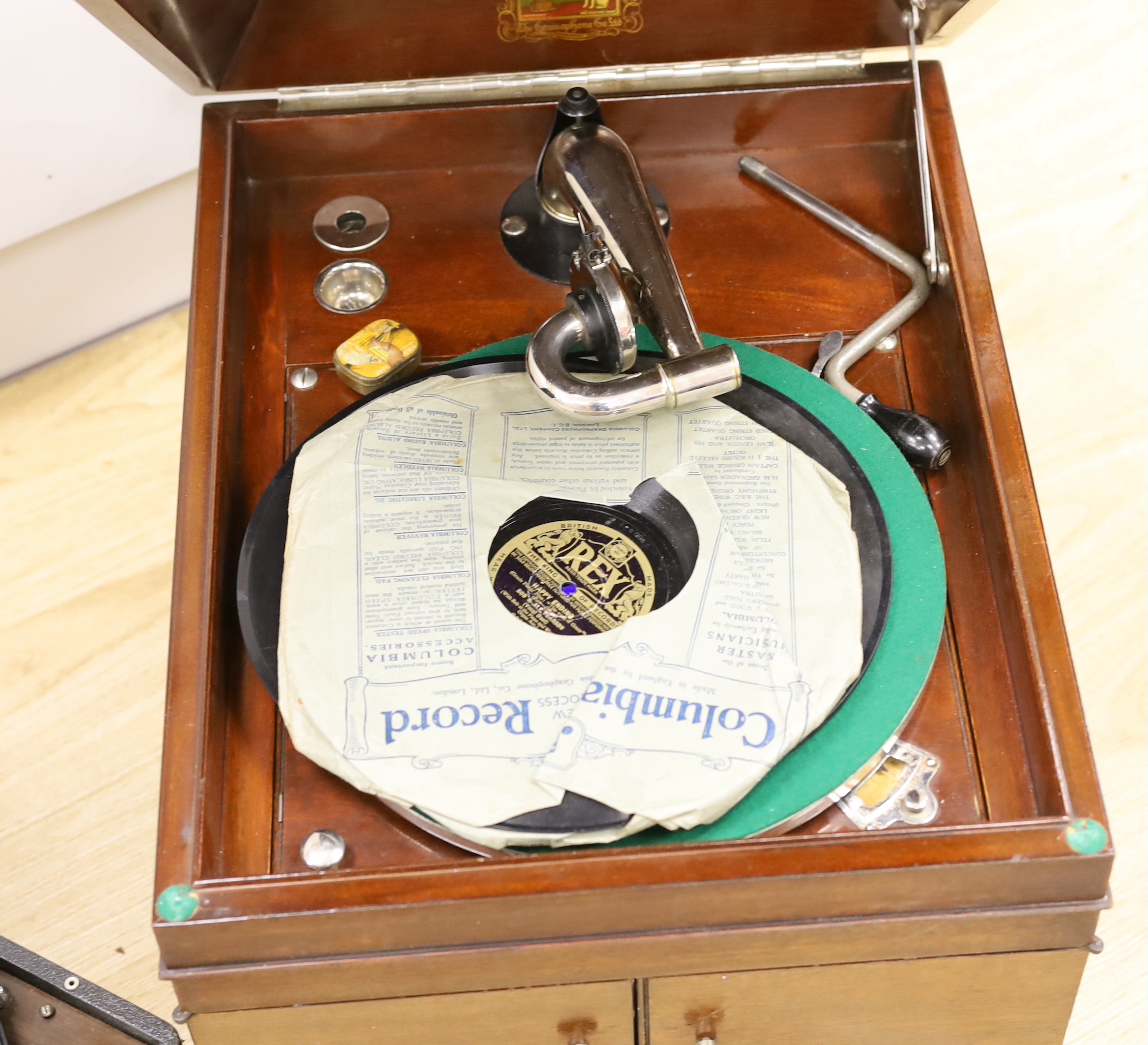 An HMV gramophone and a portable HMV gramophone, together with a small number of 78s